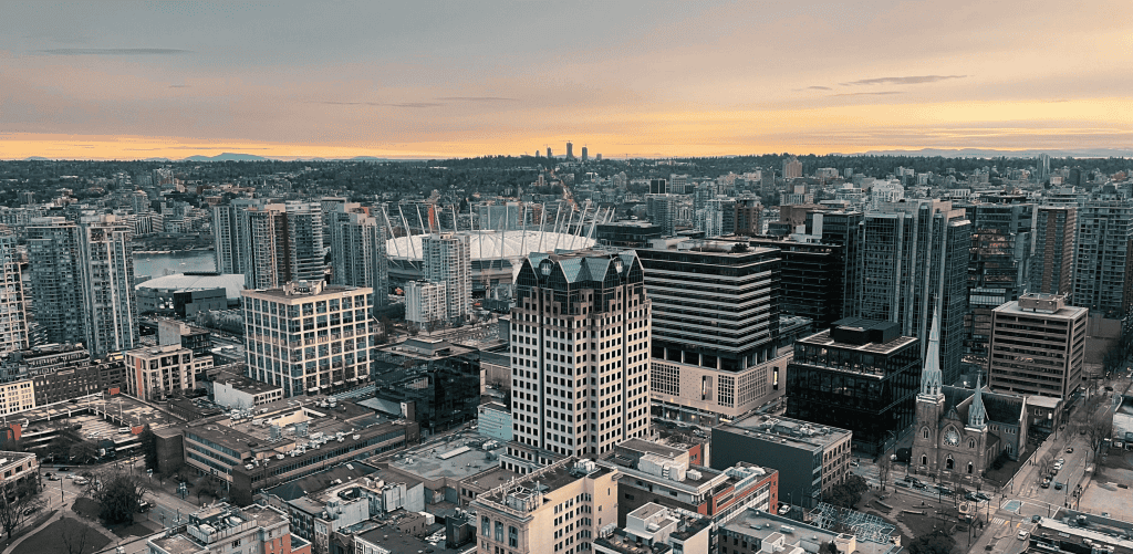 Daytime Vancouver skyline. We produce sustainable Made in Canada kitchen systems, providing career growth for local youth in BC.