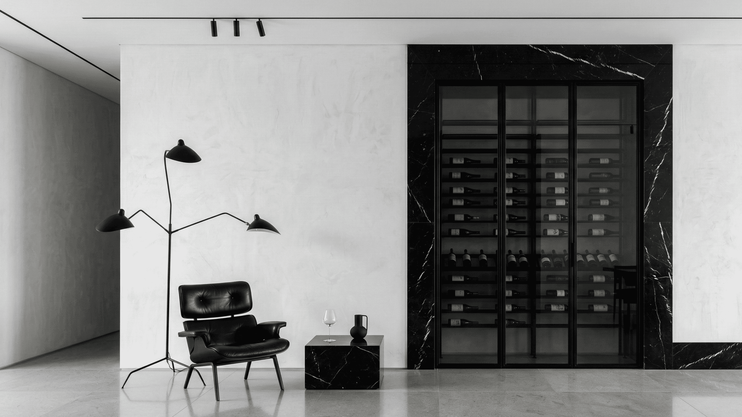 Ultra-minimalist wine display cabinet framed in striking black marble with sleek glass doors. Contemporary bespoke millwork designed for high-end gallery-style Vancouver residences.